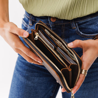 Canyon | Model holding large accordion leather wallet with zipper open