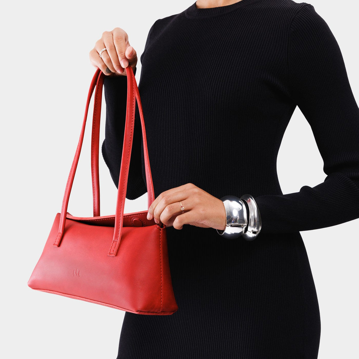 Ruby | Person holding leather bowler bag with magnetic closure