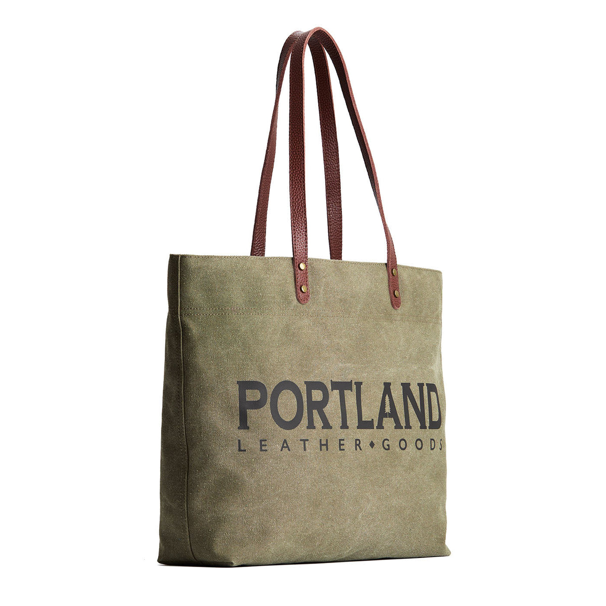 Green canvas tote bag with 'Portland Leather Goods' text and leather handles