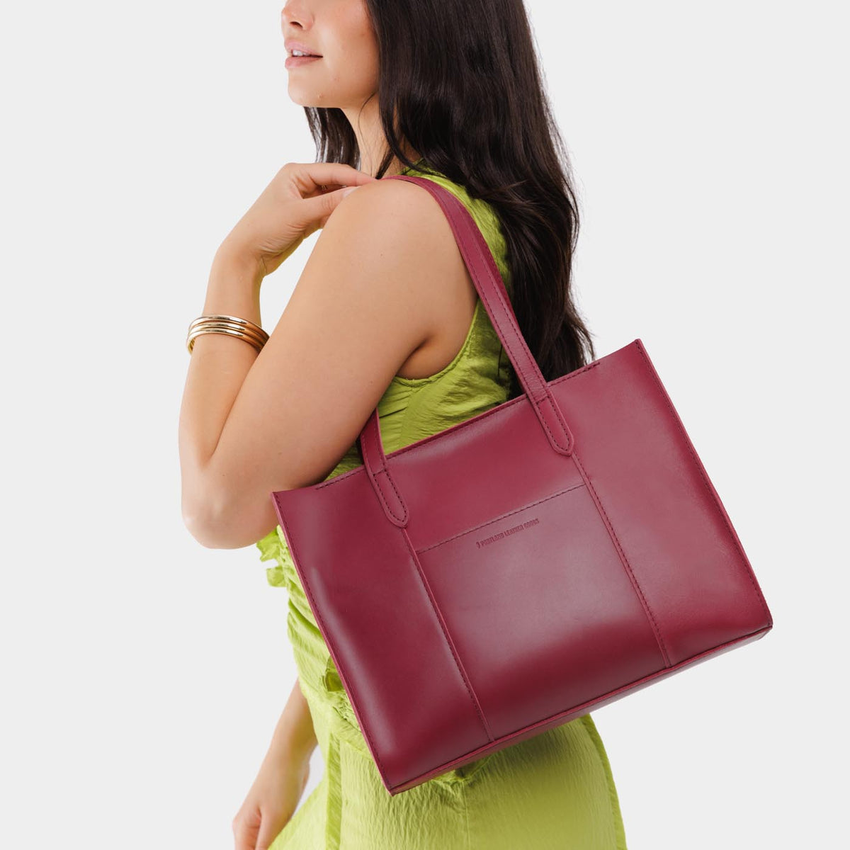 Berry Good*East/West | Model wearing structured wide tote bag with overlapping panels and crossbody strap