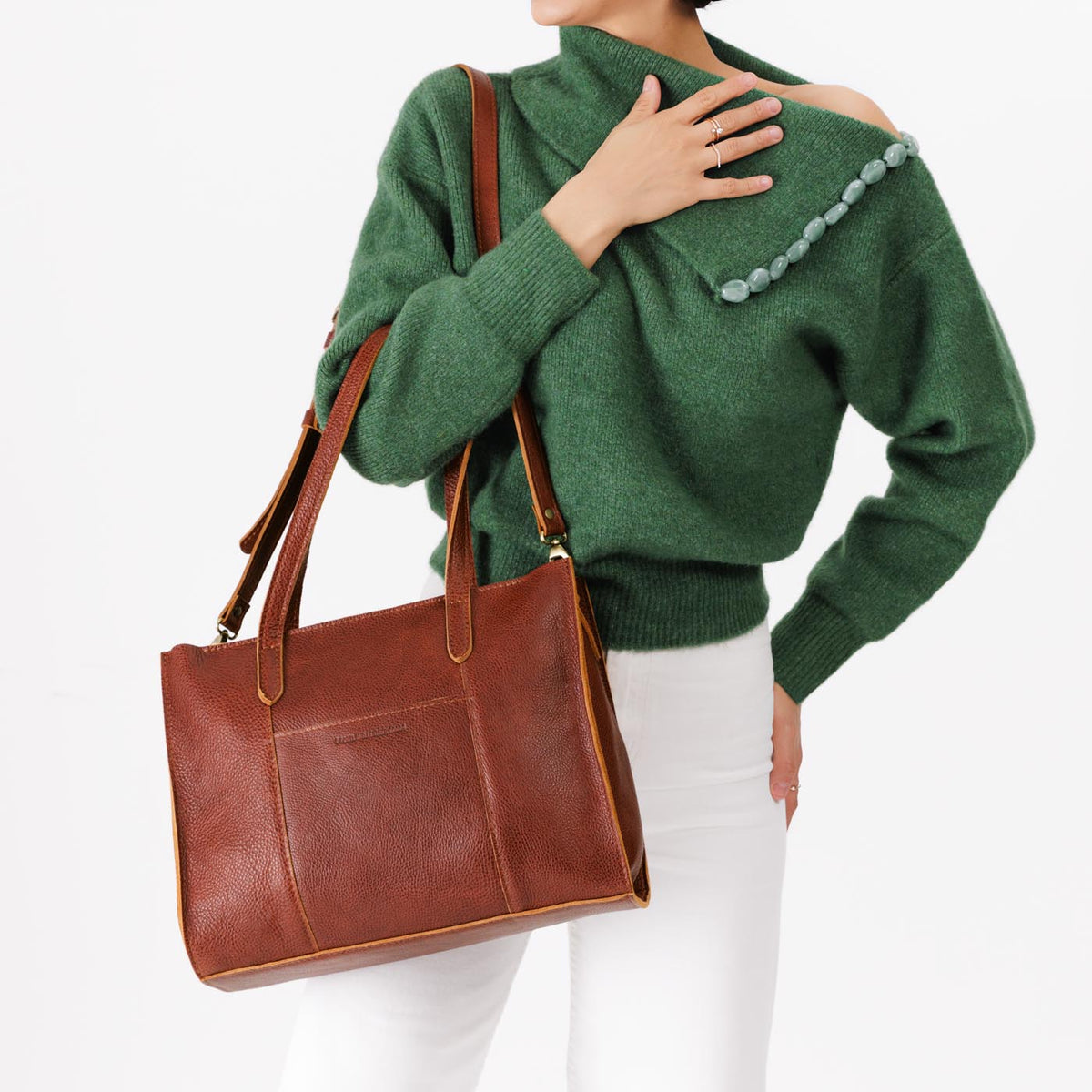 Nutmeg*East/West | Model wearing structured wide tote bag with overlapping panels and crossbody strap