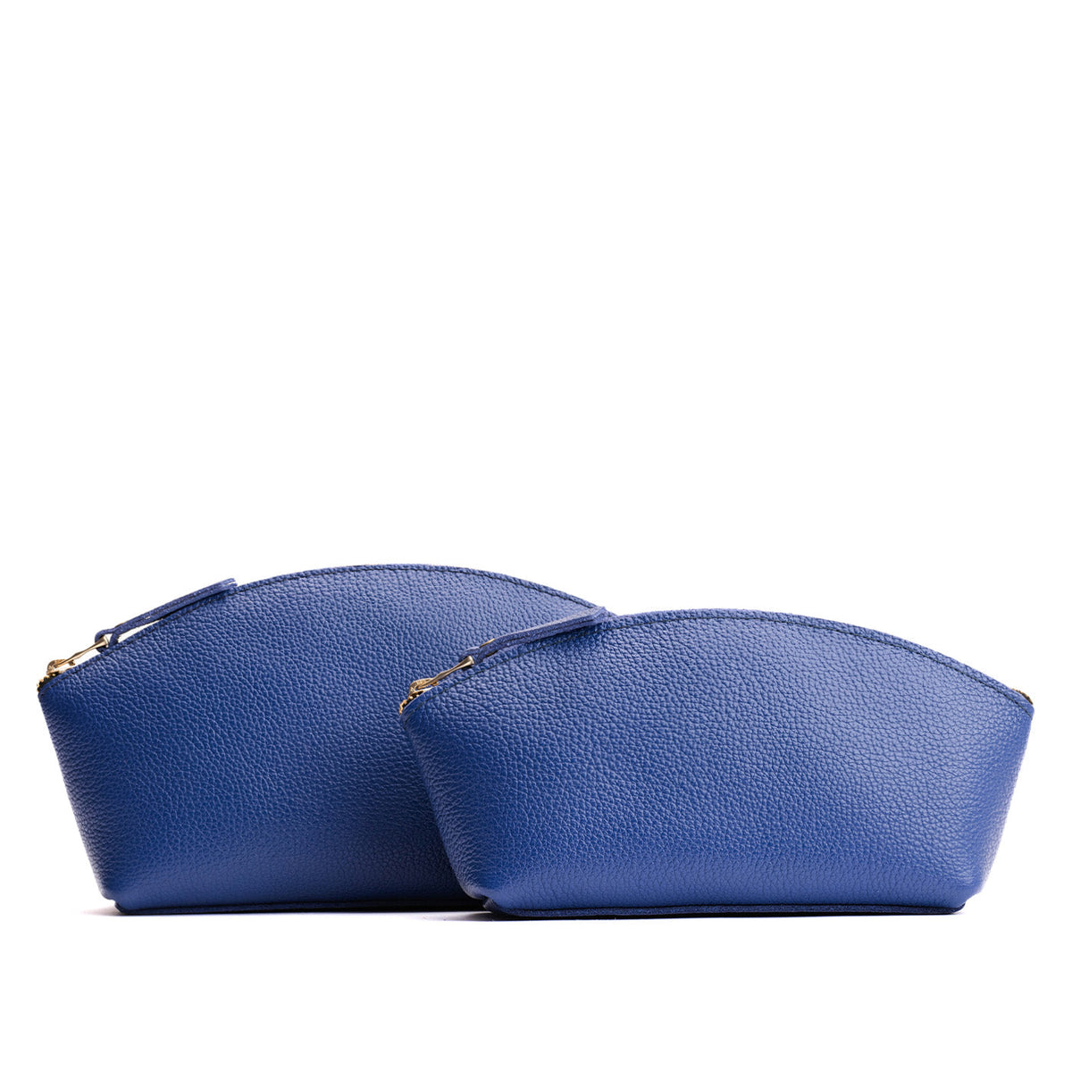Molino Blue | Size comparison shot of two spacious leather makeup bags with curved seams and top zipper