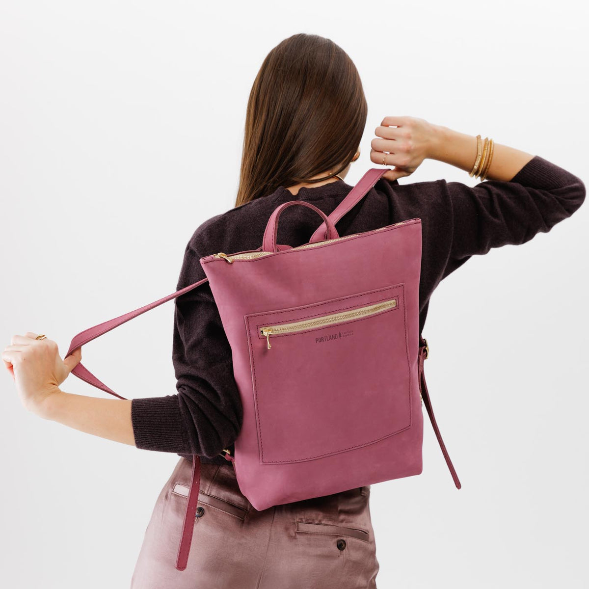 All Color: Foxglove | Model wearing rectangular slim leather laptop backpack