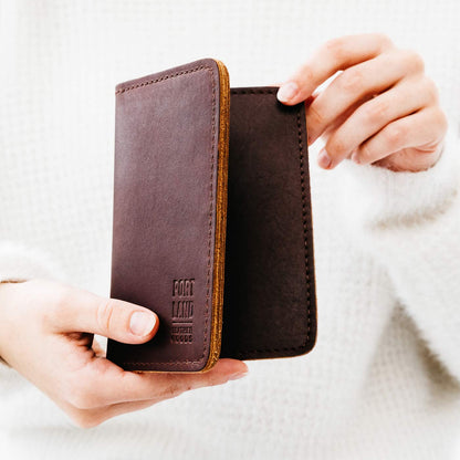 Congac | Model holding leather passport case with PLG logo