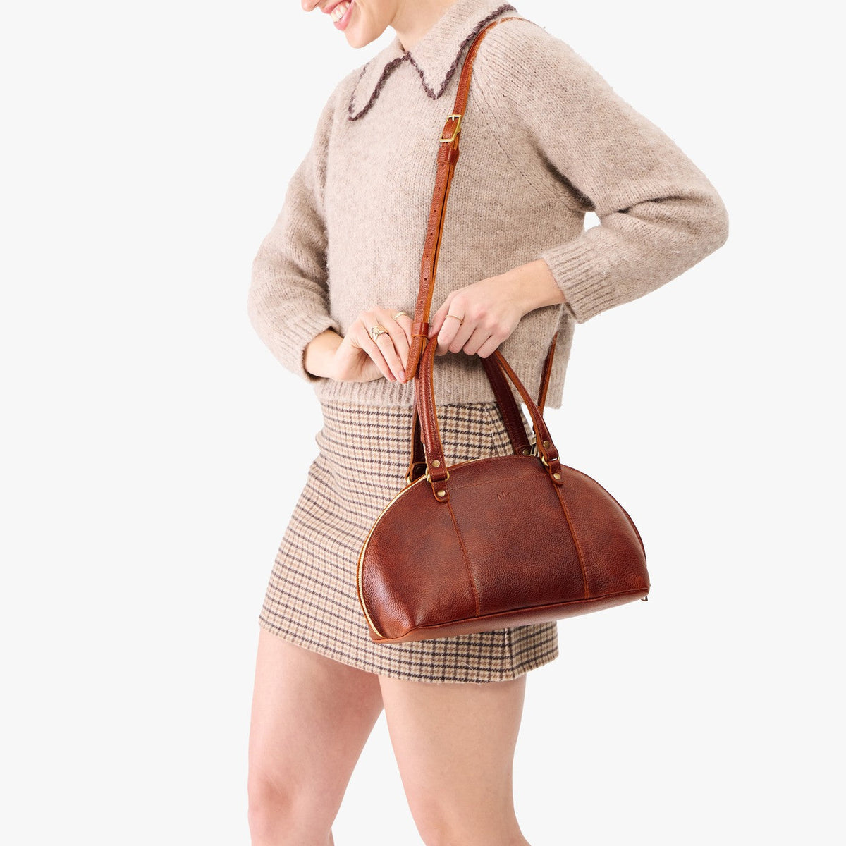Nutmeg*Small | Model holding a half circle crossbody bag with handles and removable crossbody strap