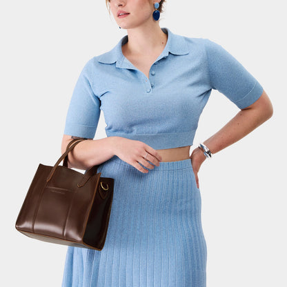 Chocolate Brown | Model wearing structured mid-size tote bag with overlapping panels and crossbody strap