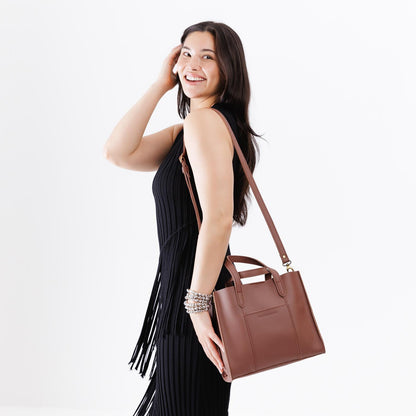 Sunkissed | Model wearing structured mid-size tote bag with overlapping panels and crossbody strap
