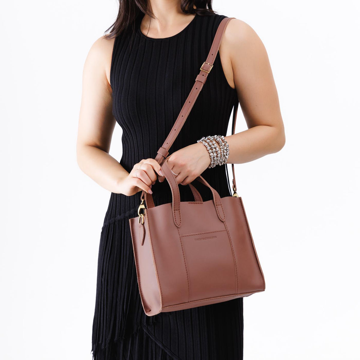 Sunkissed | Model wearing structured mid-size tote bag with overlapping panels and crossbody strap