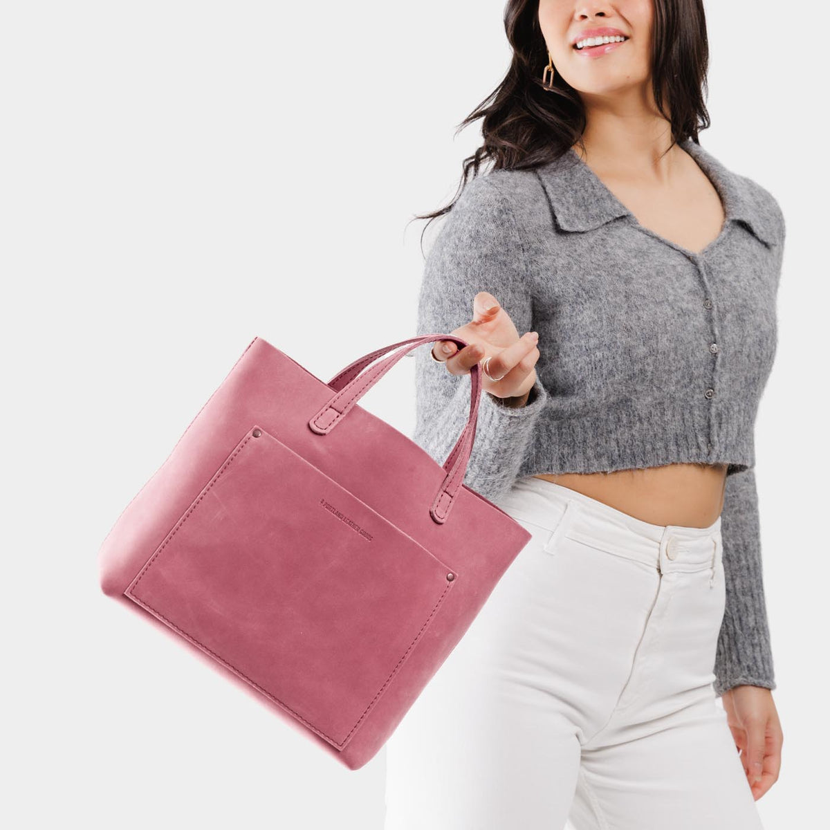 Foxglove | Model holding midsize crossbody tote with handles and a pocket