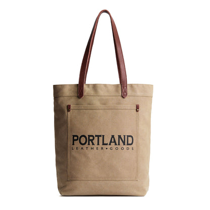 Beige tote bag with leather handles and 'Portland Leather Goods' text