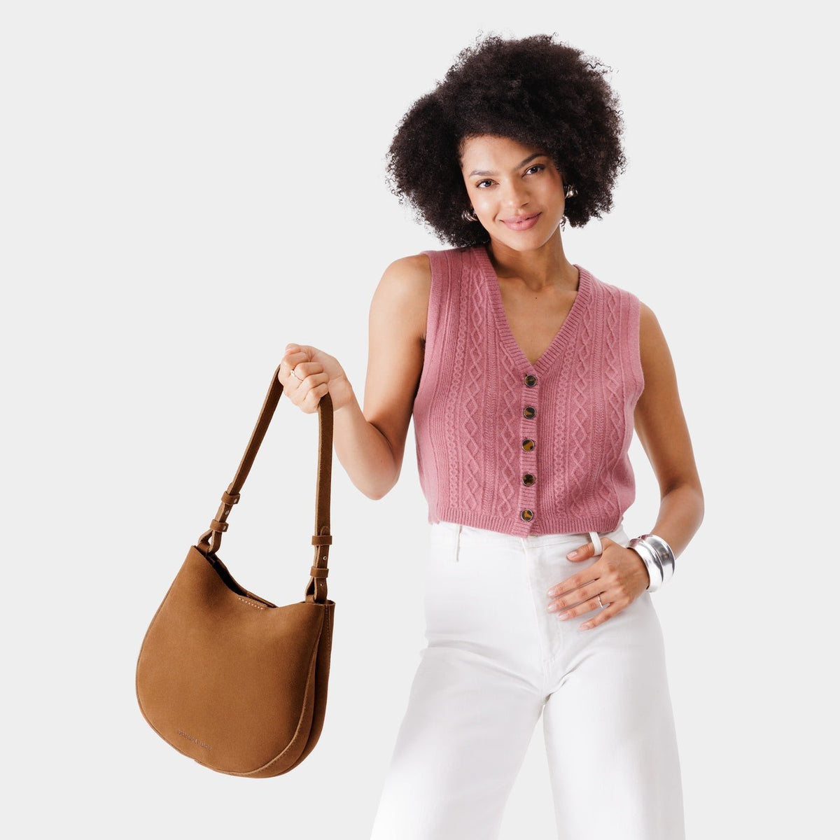 Jackson*Medium | Woman wearing rounded shoulder bag with adjustable strap on a white background