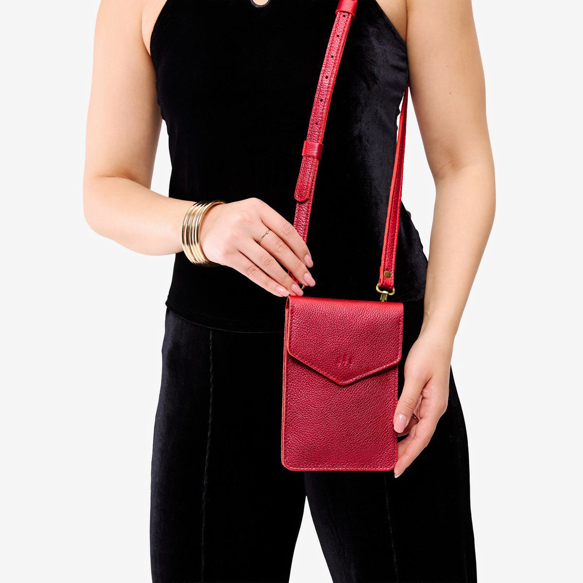 Reba Red | Model wearing slim, phone-shaped crossbody purse with magnetic closure