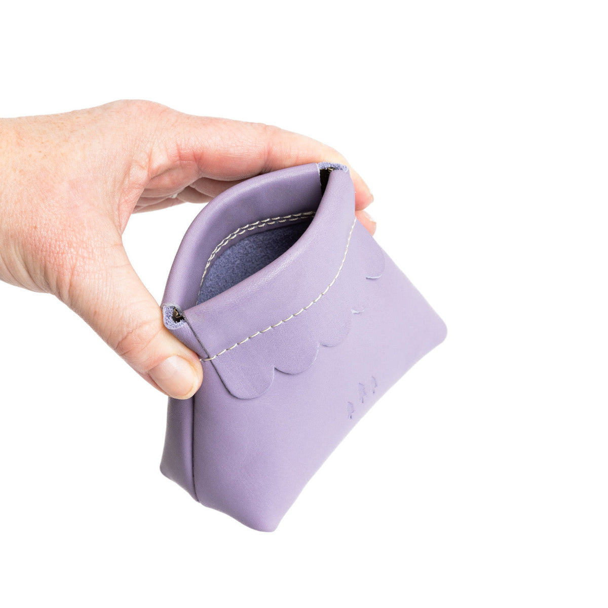 Lavender | Hand holding leather coin pouch with scalloped edge and three Portland leather tree emblems open