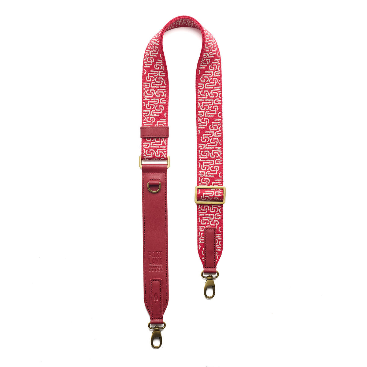 Firepop | Leather and webbing strap with repeating PLG lettering on a white background