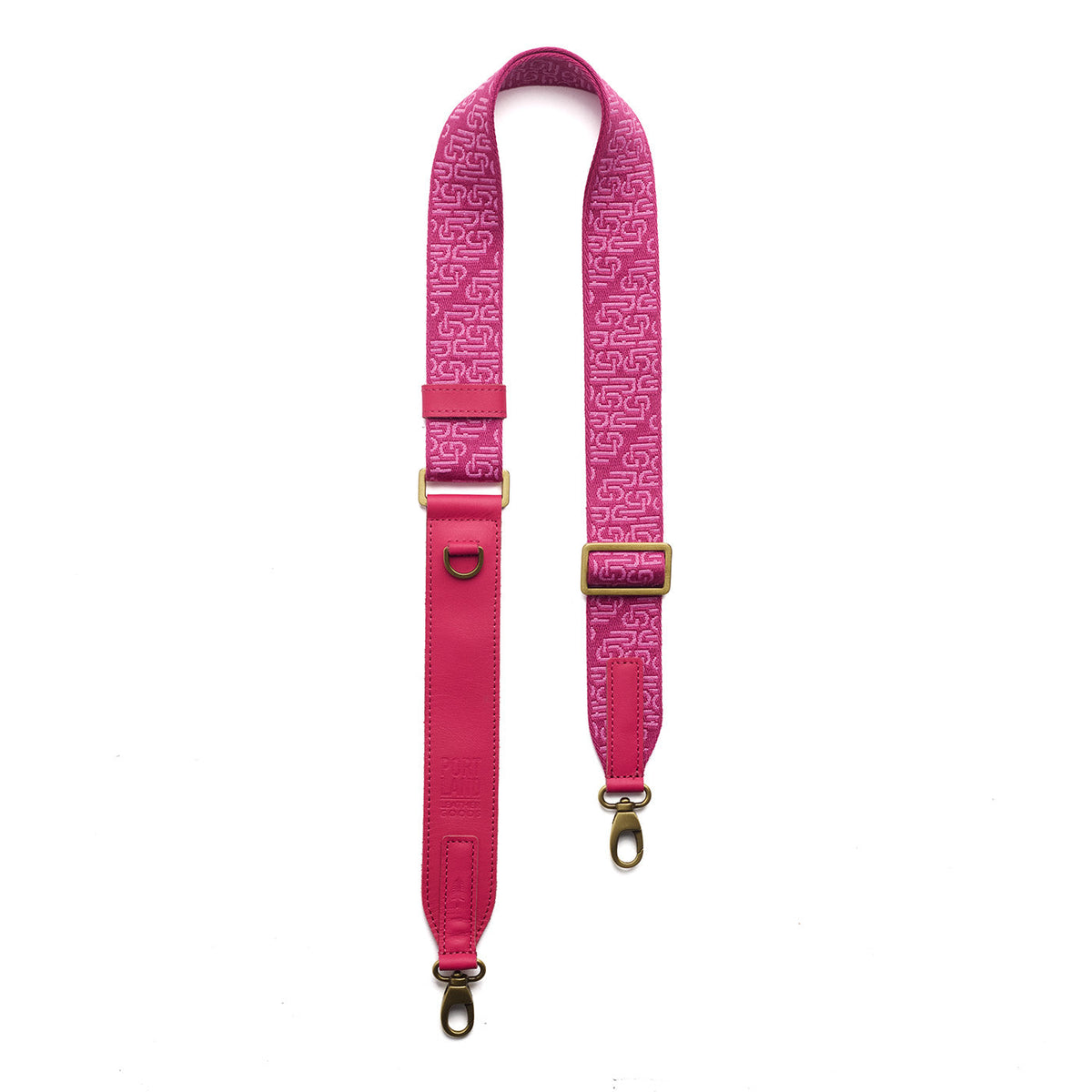 Pink Punk | Leather and webbing strap with repeating PLG lettering on a white background