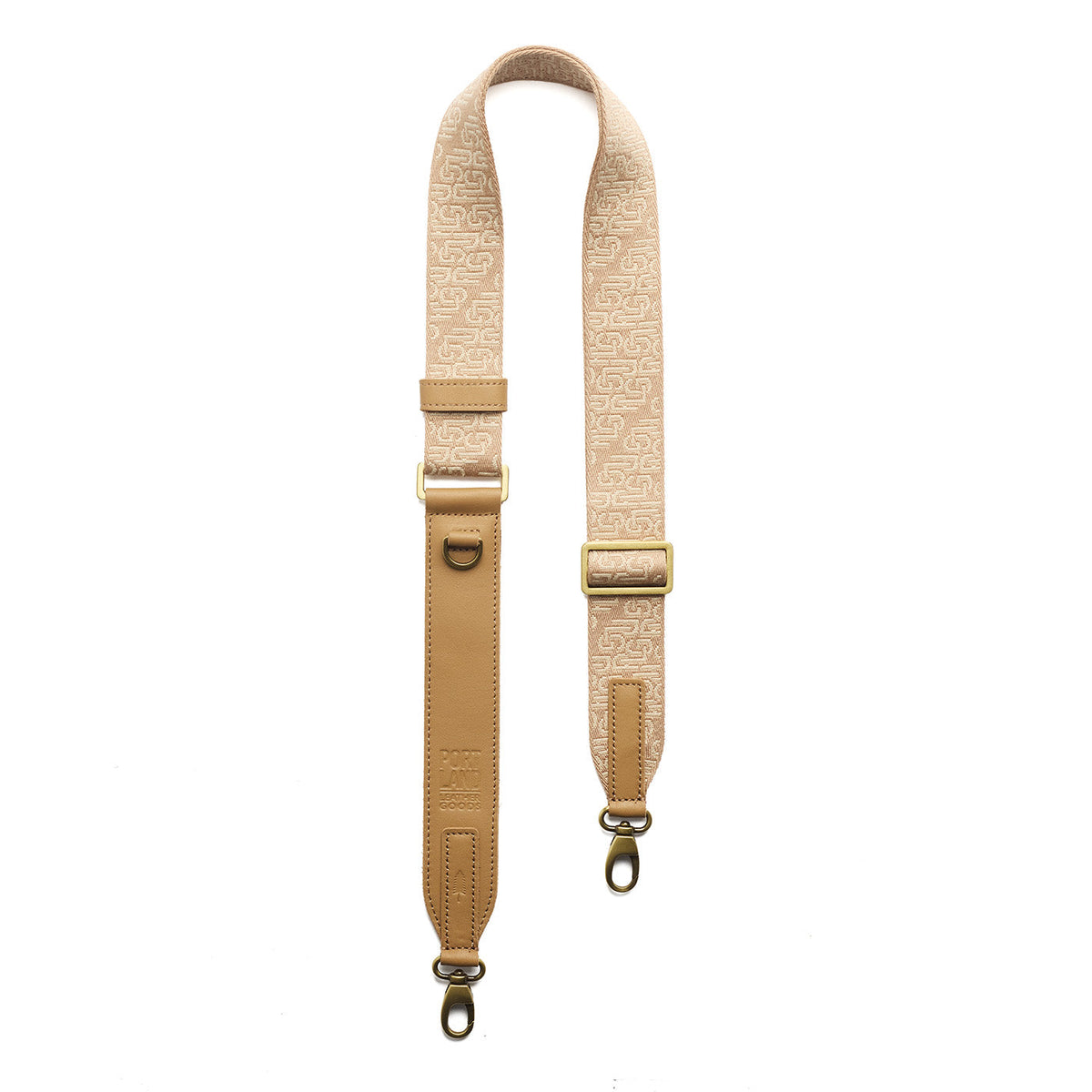 Sahara | Leather and webbing strap with repeating PLG lettering on a white background