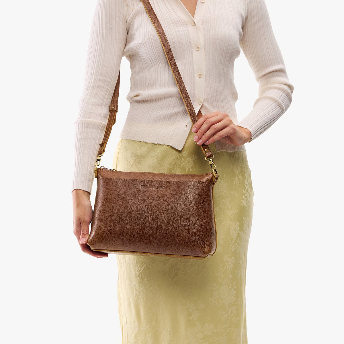 Asheville*Large | Model holding a zip top crossbody bag with detachable strap