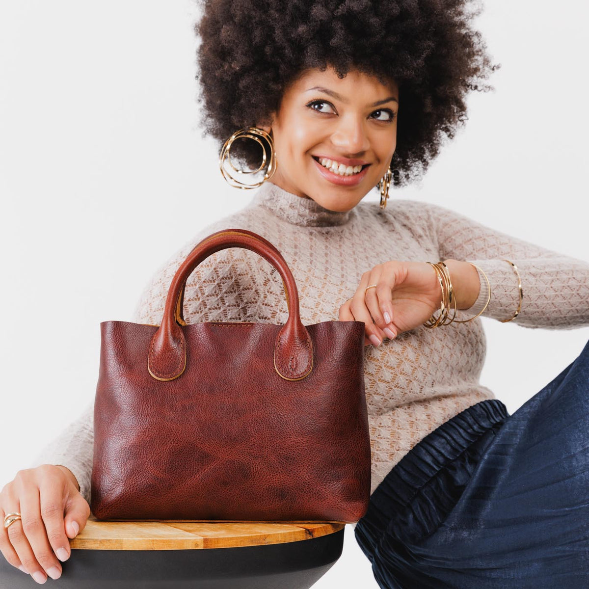 Cinnamon Bear*Large | Model holding mid-size tote purse with structured leather handles and crossbody strap