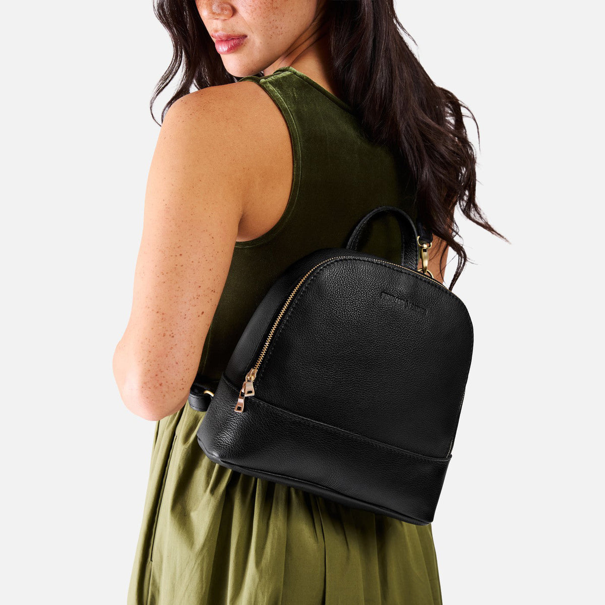 Pebbled--black | Model wearing leather backpack sling bag style