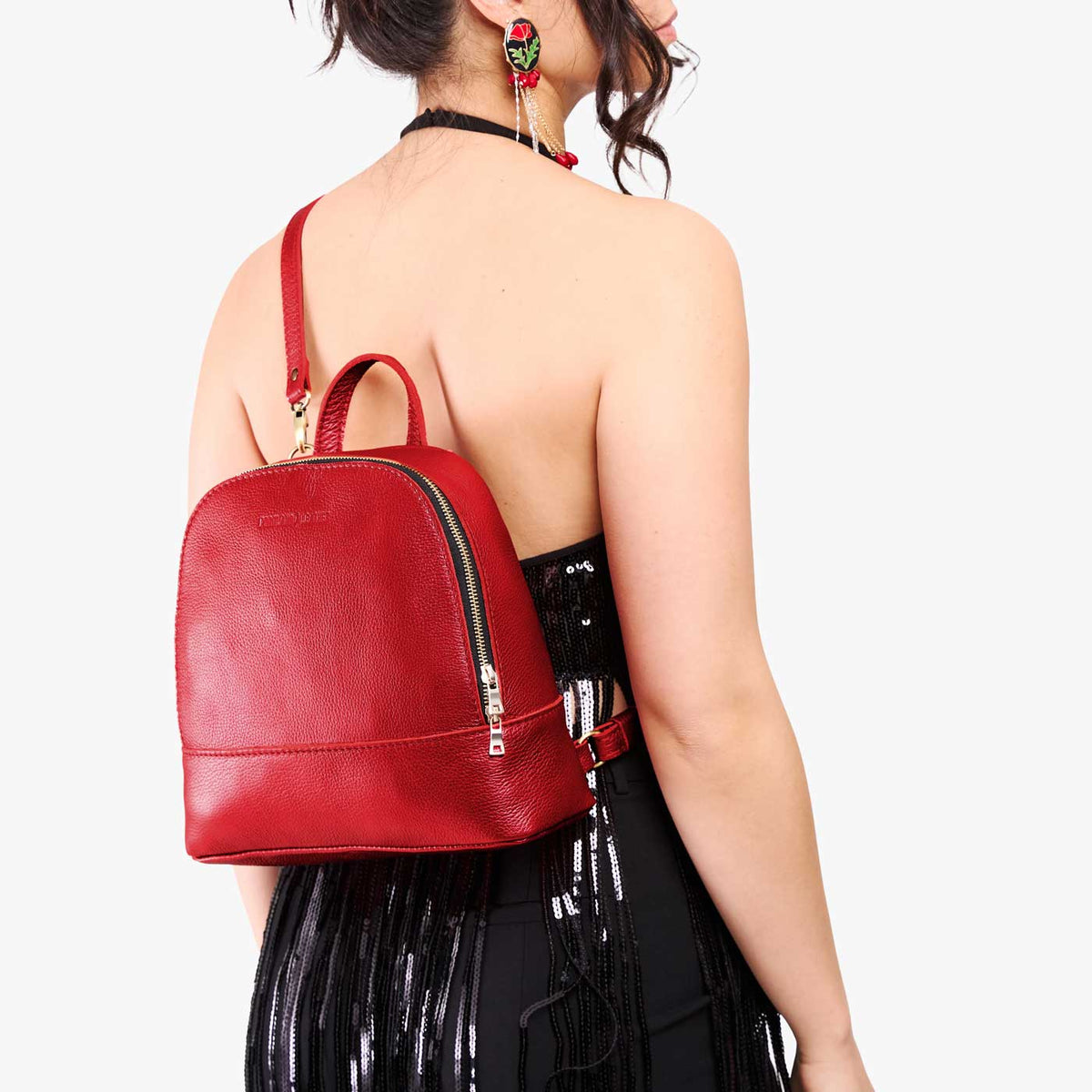 Reba Red | Model wearing leather backpack sling bag style