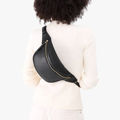 Black | Model wearing a sling bag with front zipper