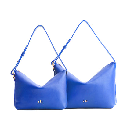 Astro Blue | Size comparison shot of small and large slouchy leather shoulder bags with zipper opening and three metal tree emblems
