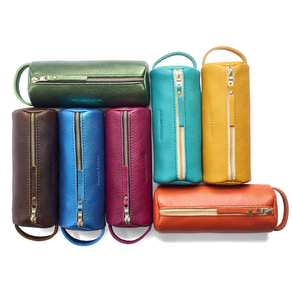 All Variants | Collection of cylindrical leather pouches with zippers and handles