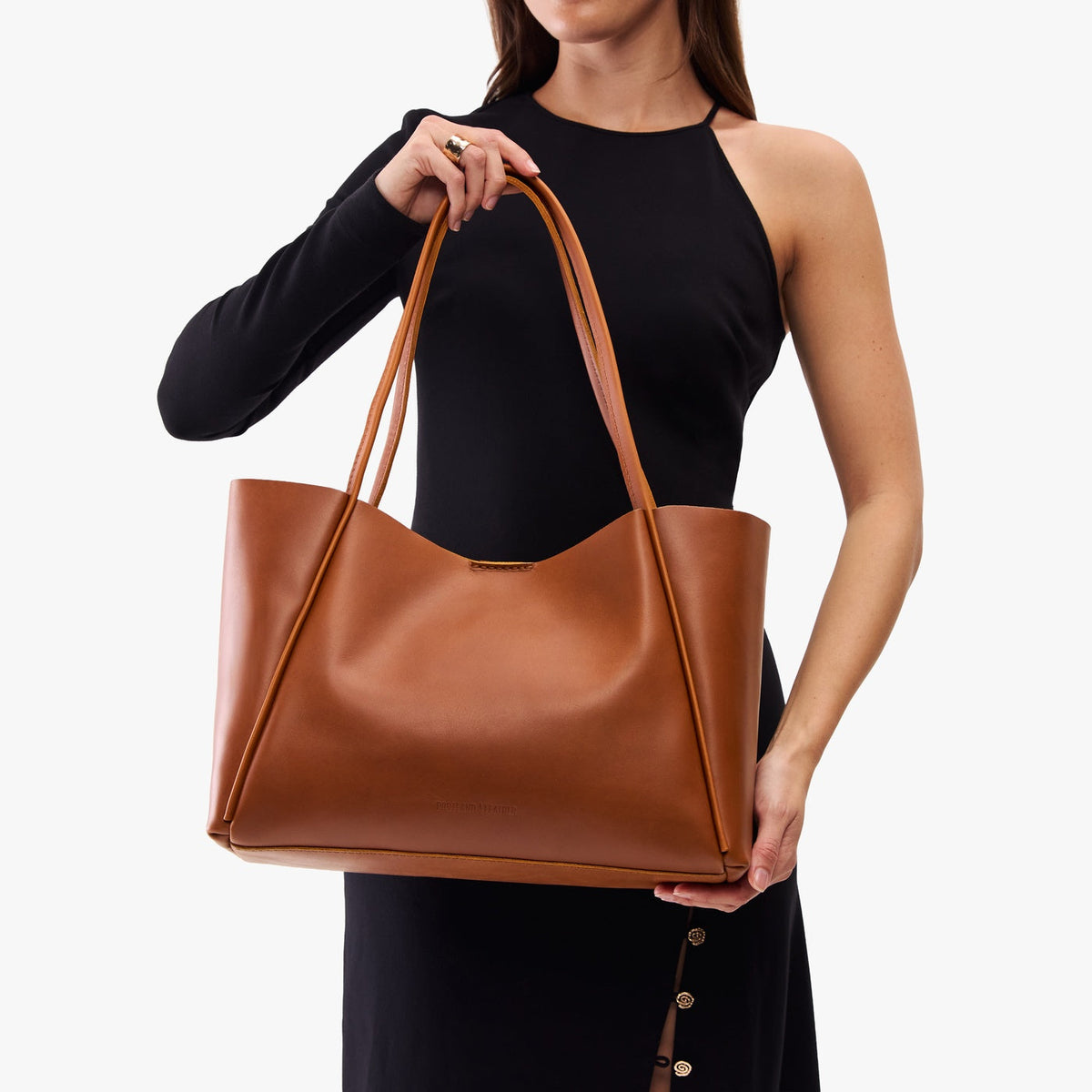 Honey*Large | Woman carrying a wide tote with leather straps and snap closure