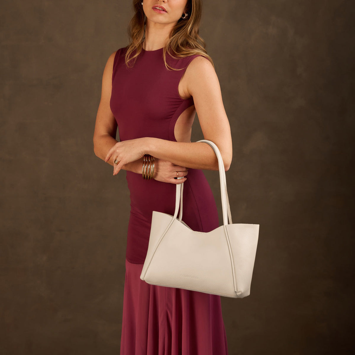 Pebbled Bone*Medium | Model holding midsize rectangular tote bag