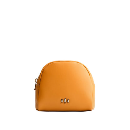 Sunflower | Curved top leather pouch with zipper opening, flat base, and three metal tree emblems in front